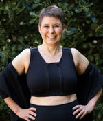 Zip-in Extender shown zipped into the HuggerPRIMA in No Moon Black. Made to vary the compression & breathability of the HuggerPRIMA for women in the process of breast surgery or with lymphedema who may have variable cup sizes and want to adjust the fit; women who are post-surgical and need compression 24/7 but would like a bit more space for sleeping or warmer weather; anyone who wants to adjust the size and fit of their HuggerPRIMA without buying an extra bra.